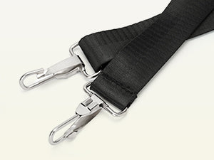 Black strap with metal carabiners on a white background